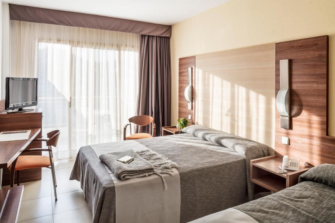 rooms-premium-triple-room-pool-view-or-partial-sea-view with-balcony